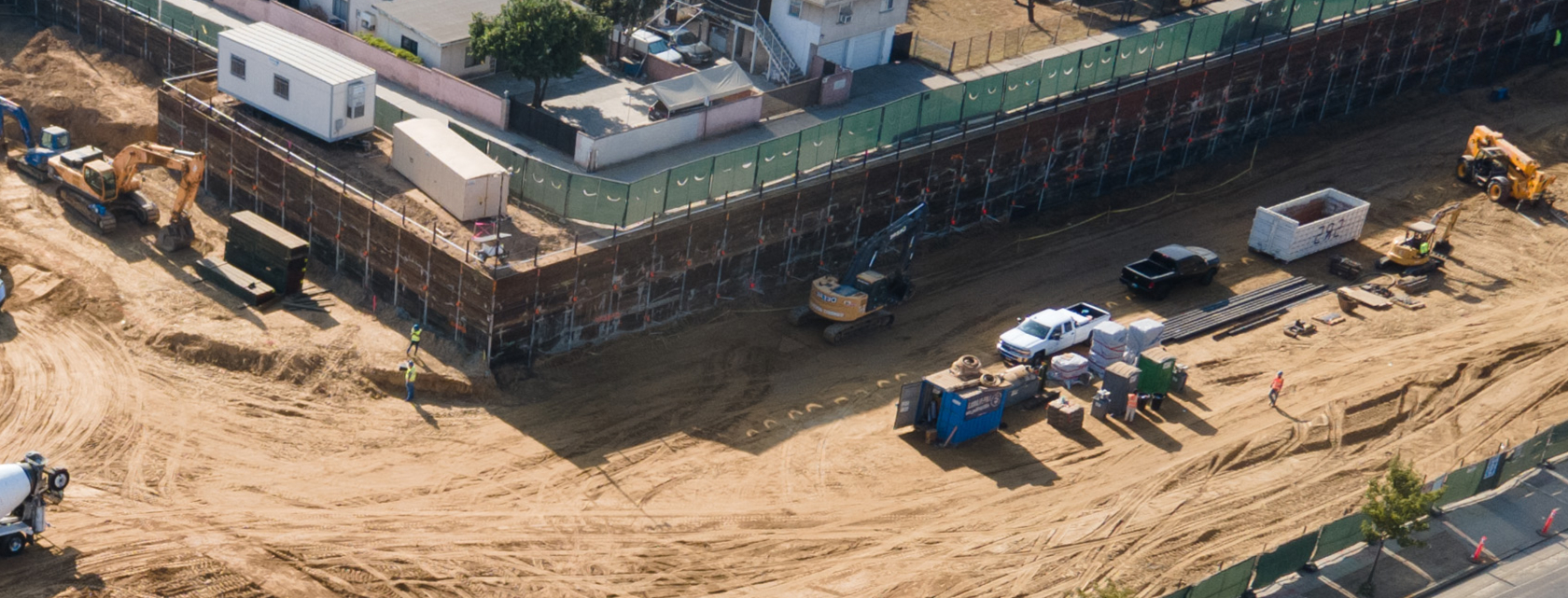 Aerial view of shoring and deep foundation drilling at active construction site