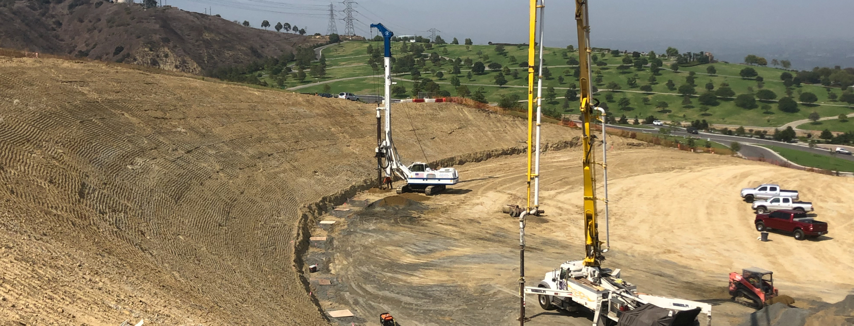 Heavy civil drilling equipment working on large earthwork and infrastructure site