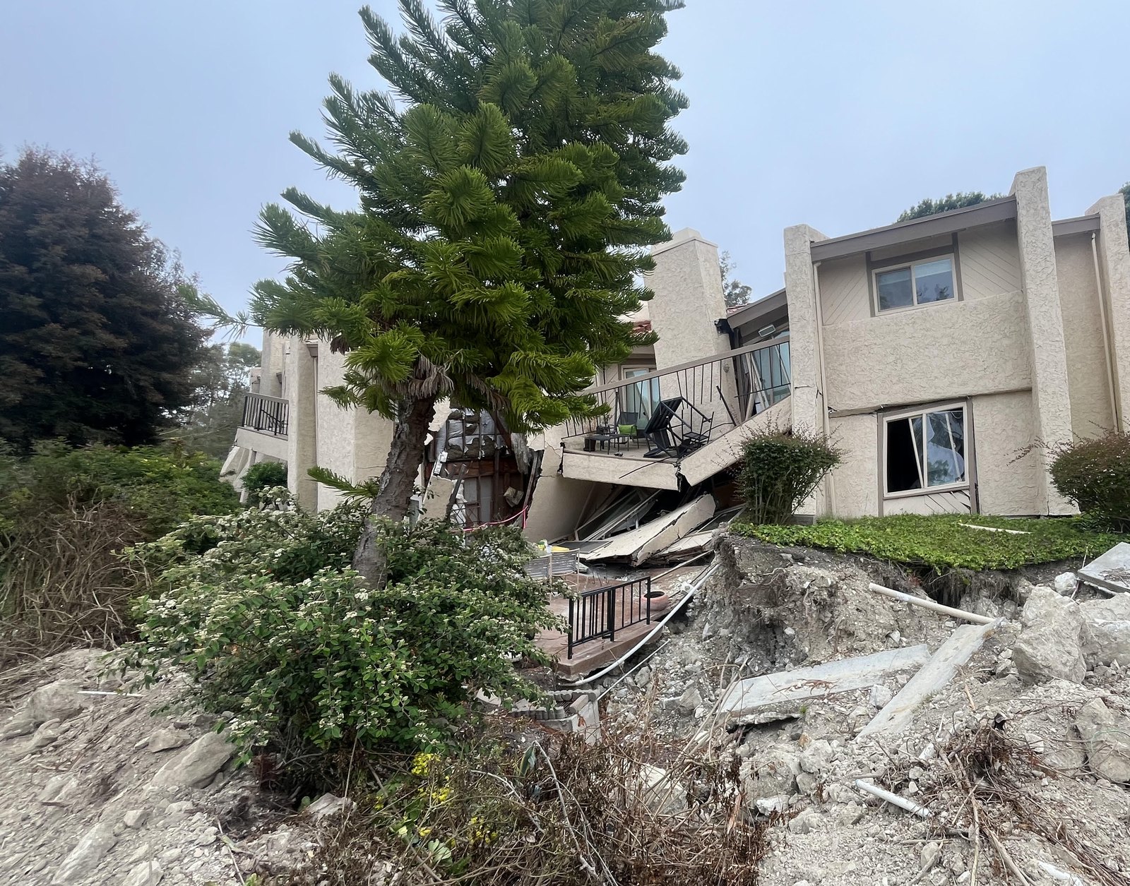 Slide damage on the hillside before the permanent stabilization work.